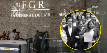 Group of people posing with a document outside a government building.